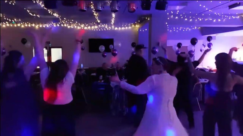 Bride and friends dancing to YMCA