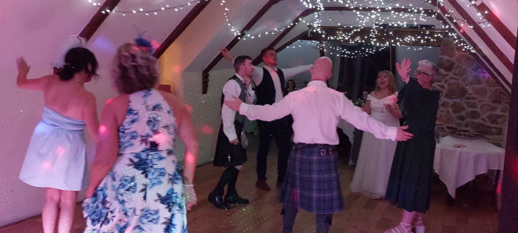 Bride, Groom and friends dancing at a wedding
