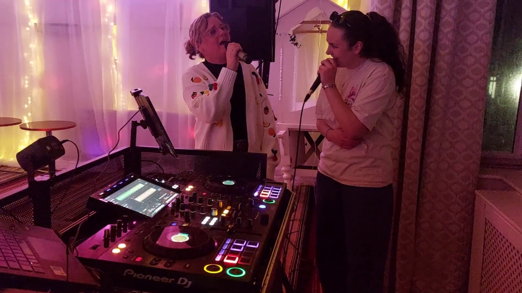 2 women singing a karaoke song