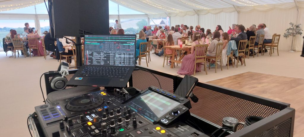  DJ set up and speeches taking place in a wedding marquee